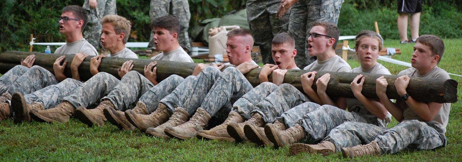 The Bruin team of (l-r) William Edwards, Isaac Kraan, George Merinich, Rowdy Houser, Nicholas Ellis, Trevor Eck, Jamie Plant, and Samuel Sexton compete in the Log Sit-ups at the Allen County-Scottsville High School Patriot Challenge.