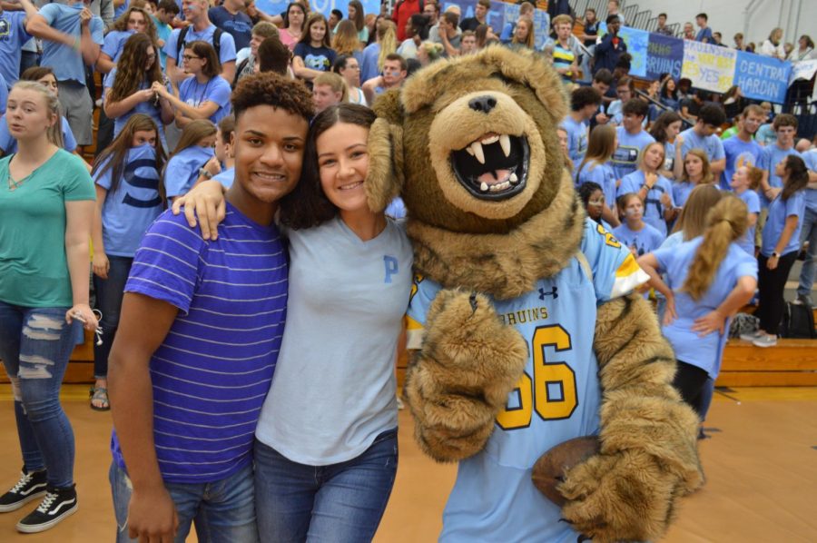 School Colors: Deion Lindsey and Rachel Cummins take a picture with the mascot while dressed in their class colors.