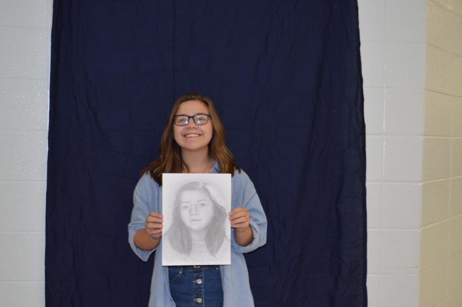 Sophomore, Elisea Conto with her portrait.