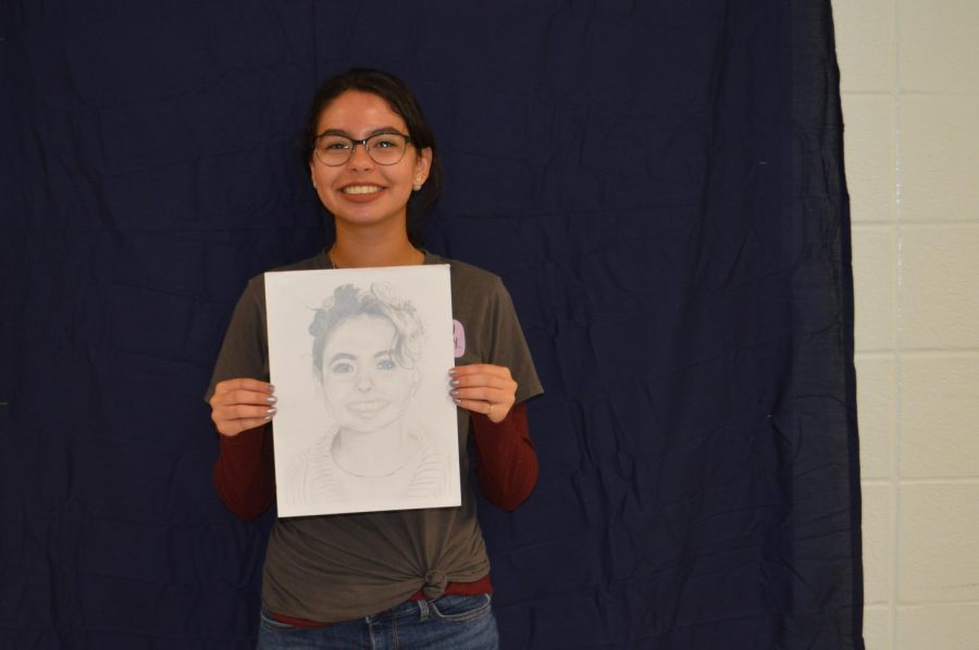 Sophomore, Lilah Sullivan with her portrait.