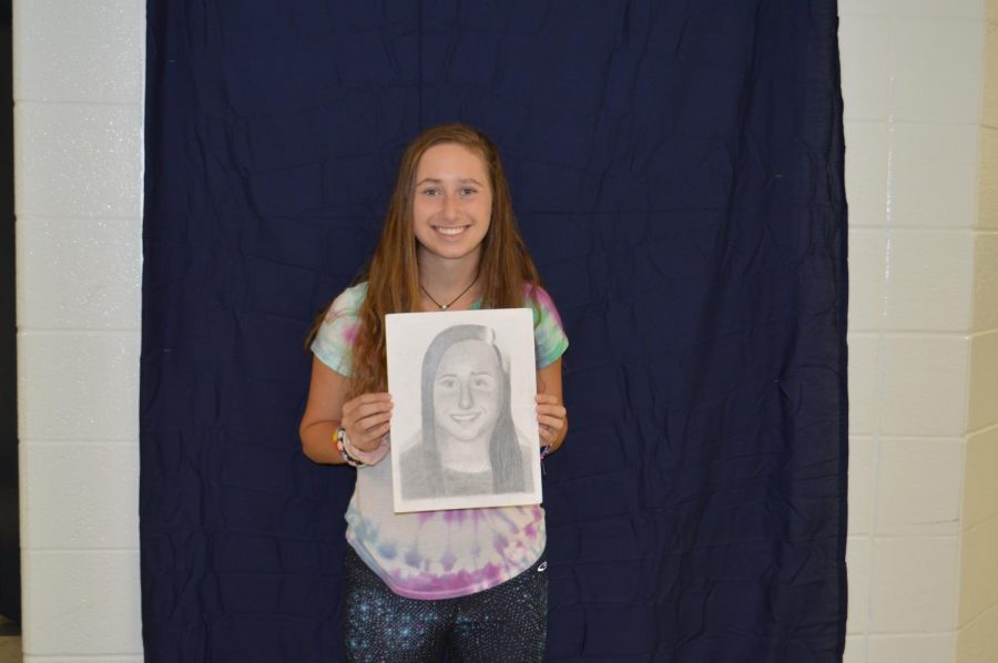 Sophomore, Meghan McGuffin with her portrait.