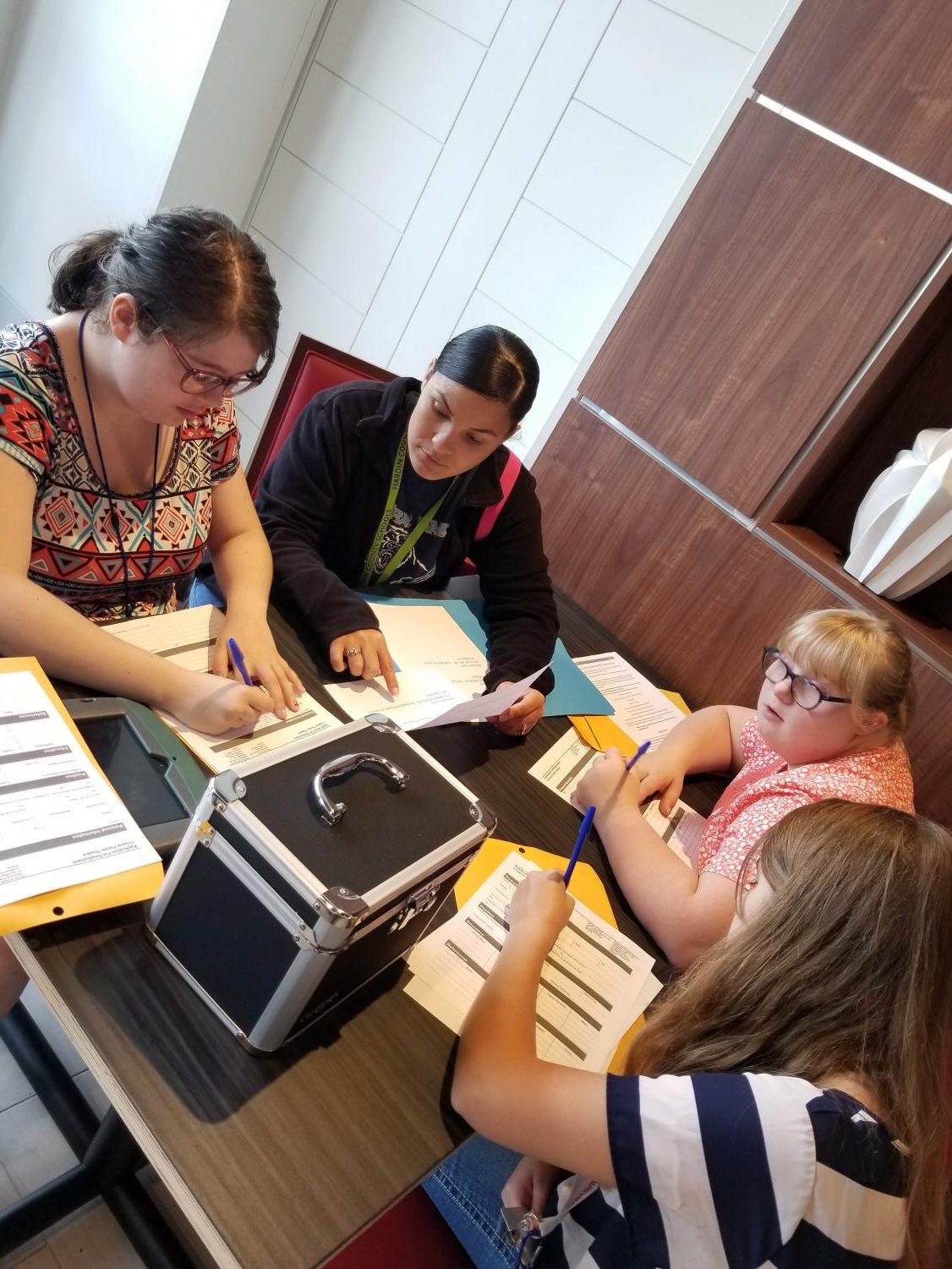 Students Makayla Loyless, Jessica Hardy, and Cheyenne Springer fill out Job Application with the help of Mercadys Truss