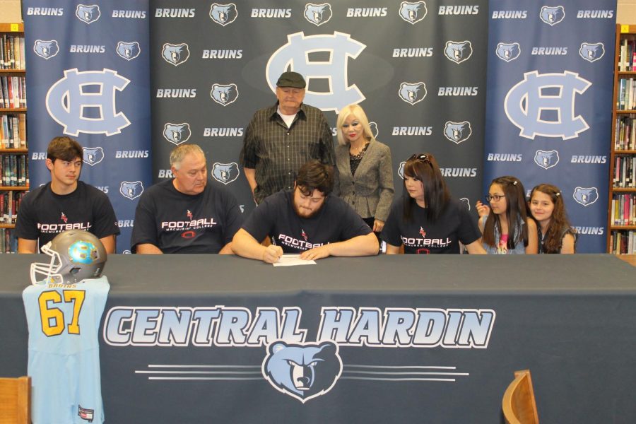 Senior+Stephen+Hill+signs+with+the+Mac+Murray+University+football+program+on+April+30th+surrounded+by+family.