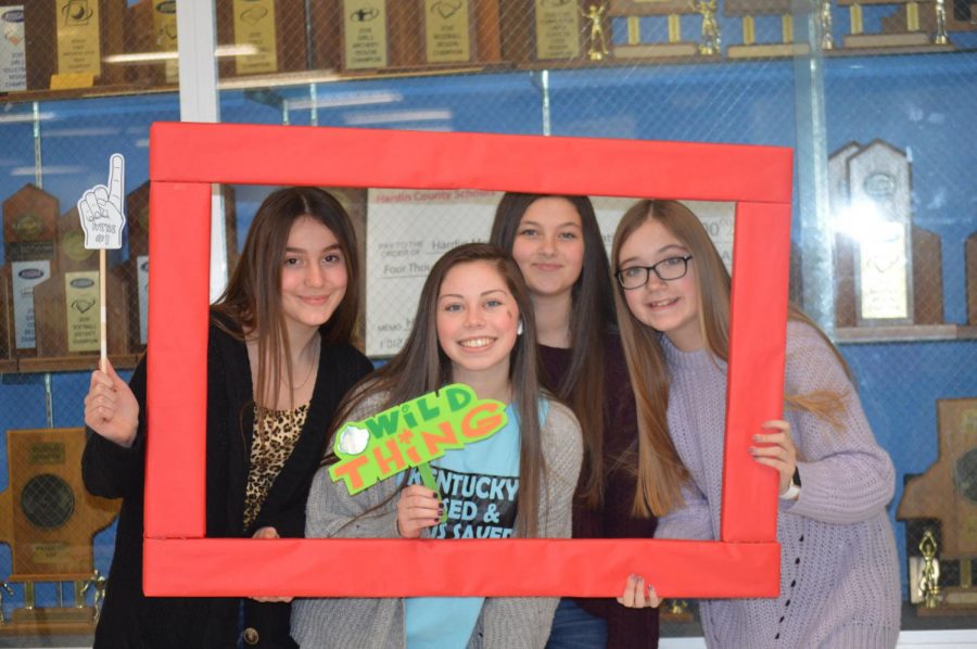 Junior Caroline Borders poses with the wild thing prop, surrounded by three freshman friends, at the FCCLA photo booth on Feb. 14..