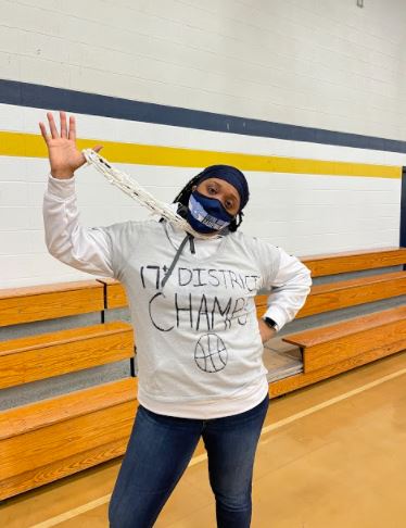 Girls Basketball Head Coach Kristina Covington-Jones dons a homemade shirt and net necklace to celebrate her teams 17th District Championship win over Elizabethtown on March 18. This win marks Centrals first District Championship since 1999