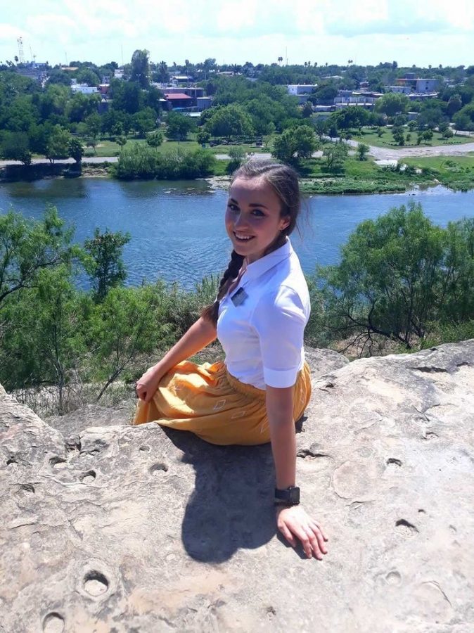 CHHS alumna, Annalese Tilley sitting in front of the Rio Grande.   Photo courtesy of Annalese Tilley 