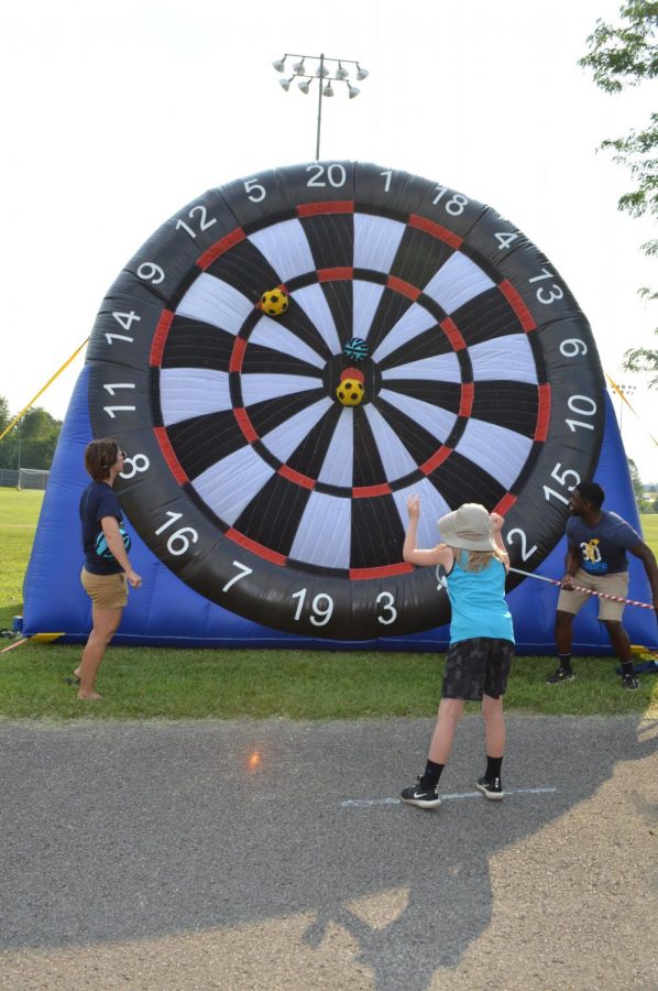 Lincoln Trail Elementary fifth grader Memphis Warren participates in the Bulls Eye game, manned by Vine Grove Elementary and J.T. Alton MIddle School Youth Services Coordinator Theresa Ovesen and Bluegrass Middle School Youth Services Coordinator Jarren Morning at the Bruin Fest on July 22 at Central Hardin High School.