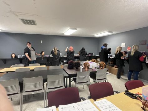 Cosmetology students working on their perm skills. 