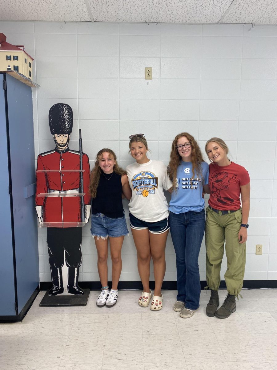 Seniors Syra Lundergan, Reese Nickell, Jenna Smith, and Hanna Grass posing with history teacher James Sisk's life-size guard (Jul. 26).