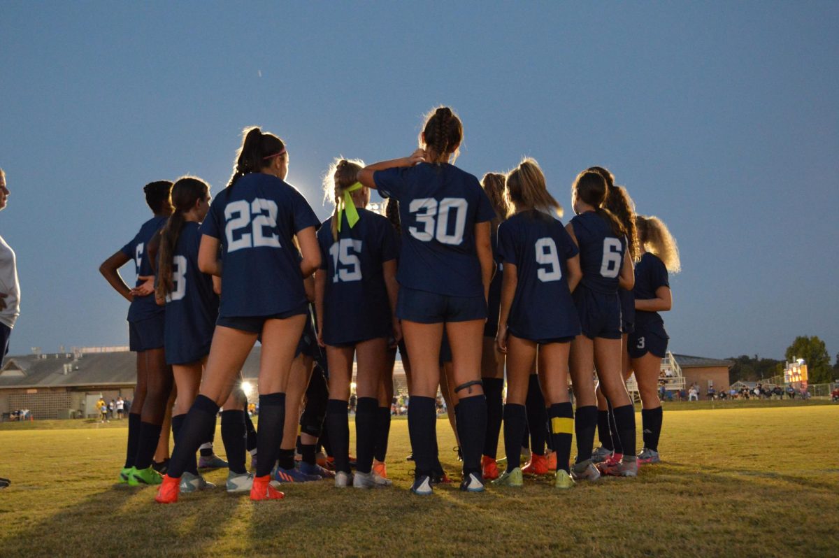 Junior varsity girls soccer team in a huddle showing their glowing commitment to the sport of soccer. (Sept. 25)