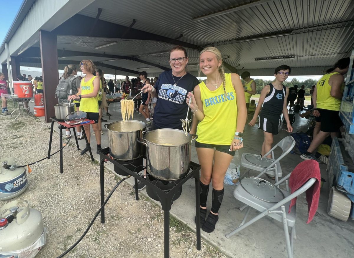 Cross-country coach Samantha Dale and junior Karsyn Clayton serving pasta to athletes at the Fairgrounds Tri-meet that Central Hardin hosted (Sept. 1).
