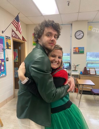 History teacher Julie Anderson hugs singer/songwriter Jack Harlow on Ugly Sweater Day at Atherton High School in Lousville in December of 2021.