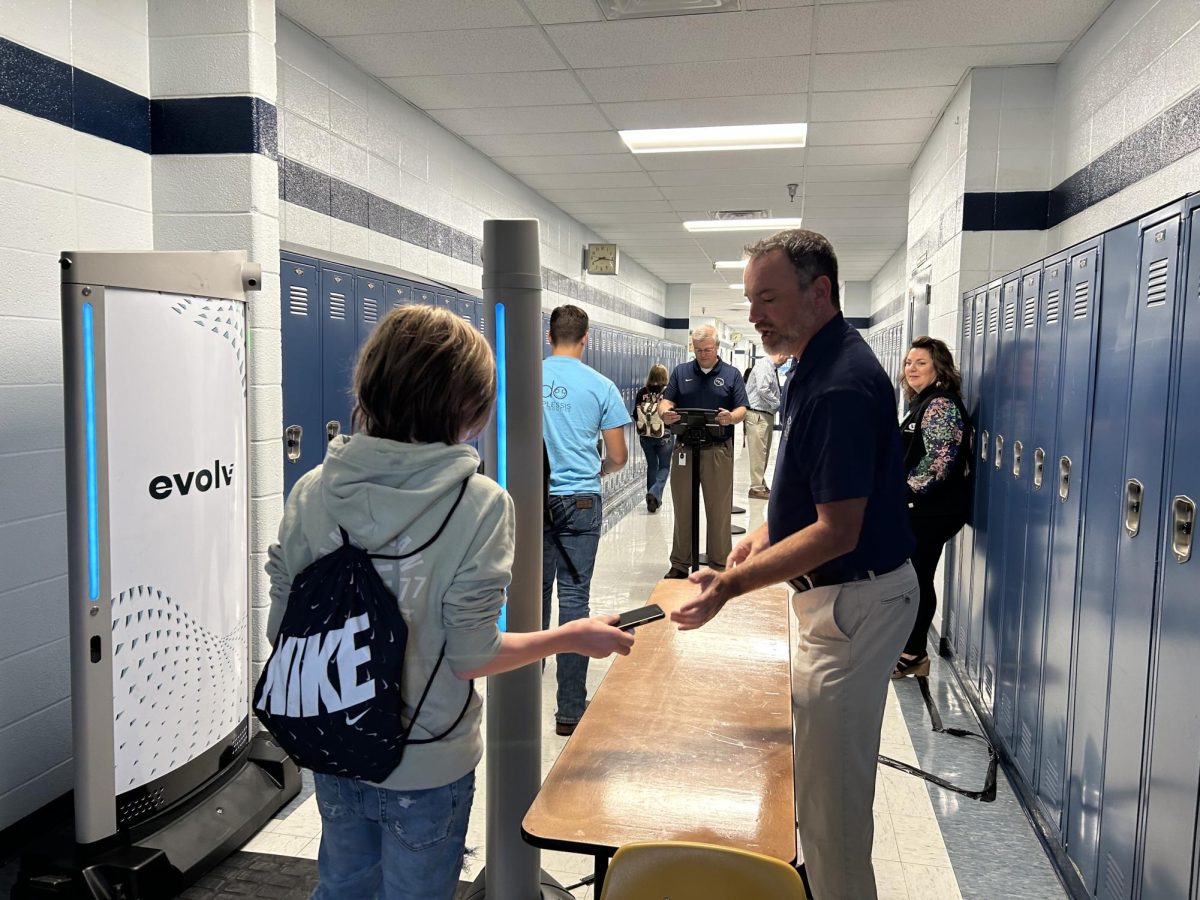 HCS Chief Operations Officer John Stith guides a student entering the Evolv Express Security System, which was tested at Central Hardin on Sept. 22. Students were asked to remove Chromebooks and three-ring binders from their backpacks before entering through the system.