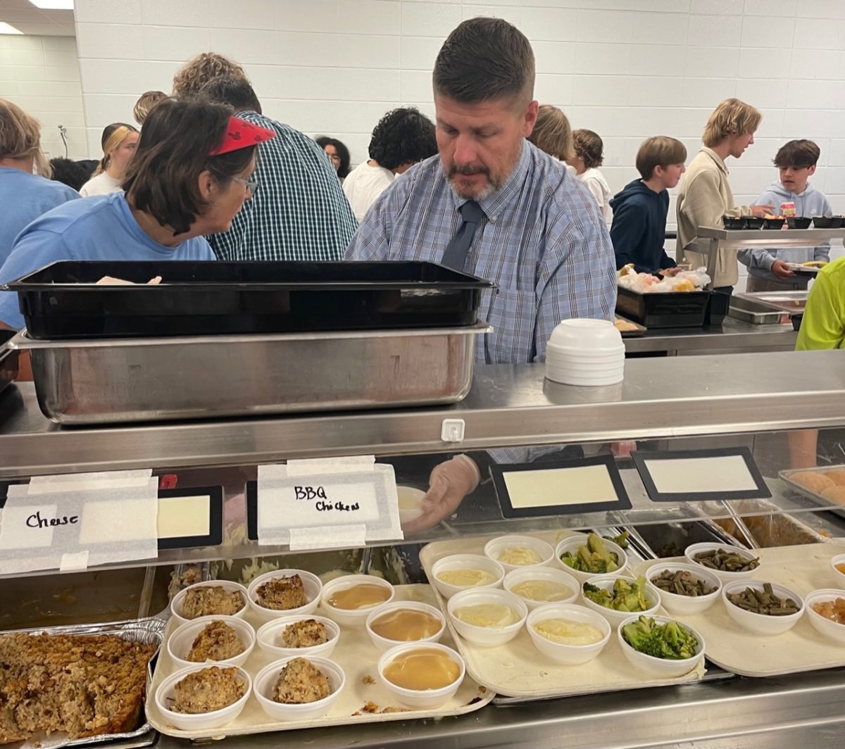 Assistant Principal Matt Baucum serves Thanksgiving lunch to students and staff on Nov. 16. It is a tradition at Central Hardin for administrators and other staff to help cafeteria staff on this day.