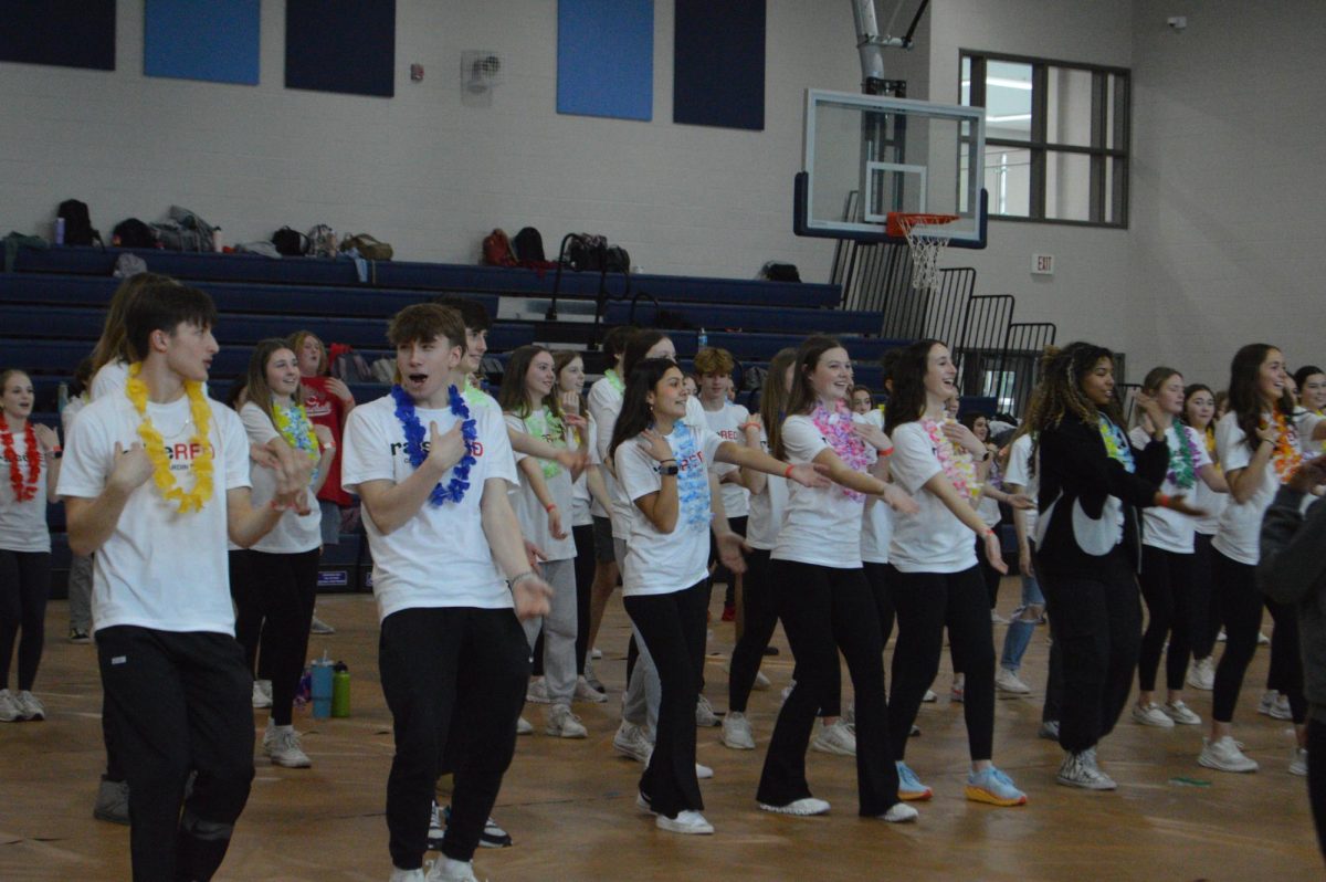 Students at the RaiseRed fundraiser learn a line dance from UofL students on (Feb 9).
