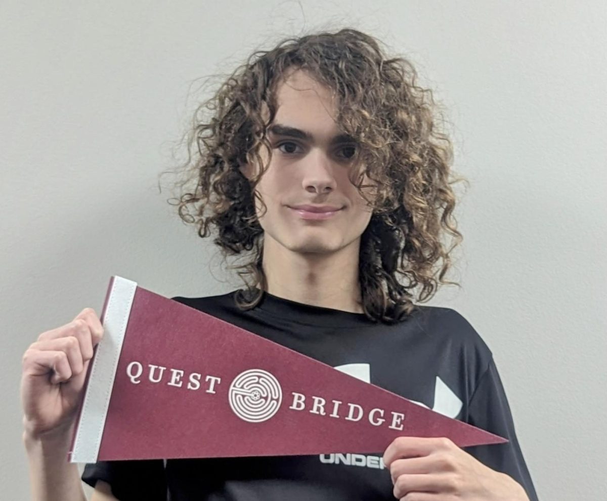 Senior Cameron Miller holds the flag of his future after receiving notice of his tremendous achievement of earning the Quest Bridge scholarship.
Photo Courtesy of Lindy Barnes.