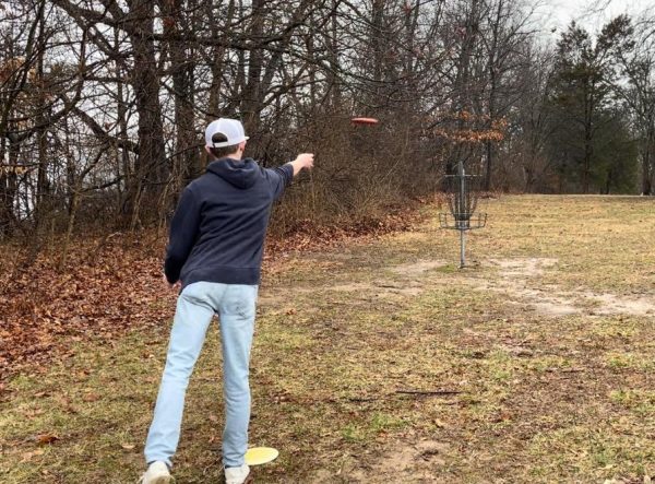 Senior Jeffery McMahan advancing on the Freeman Lake disc golf course. This is a standard disc golf basket that is considered a hole. Photo courtesy of Jeffery McMahan.
