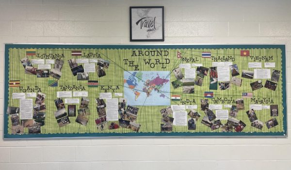 Vessels shares his travel memories through written descriptions and photos on a board display on his classroom wall. 