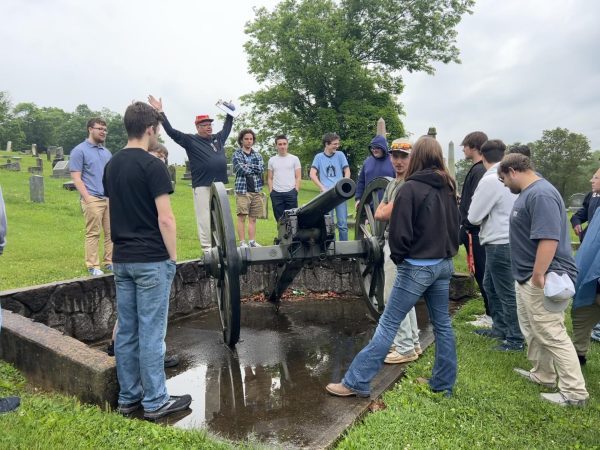 History teacher Mike Sisk explaining the significance of the cannon in the Elizabethtown City Cemetery to his military history class (May 17).