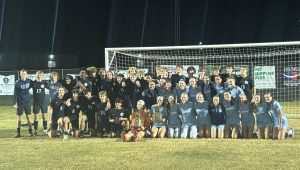 The boys' and girls' soccer teams celebrate their District Championships after defeating Elizabethtown 3-0 and 2-1 (respectively) on Oct. 10. After the girls captured their win at E-town, they traveled together to support the boys at John Hardin. 