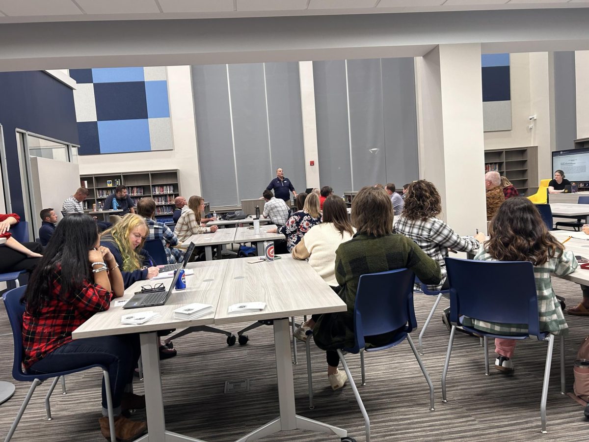 Bruin teachers listen to principal Tim Isaacs go over several items during their first faculty meeting in the new library on Oct. 31. The official Opening Day for students to visit the library is Nov. 11.