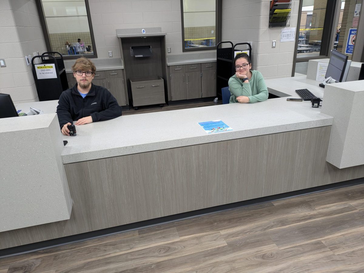 Evelyn Barner (Senior) and Walker Huff (Senior) helping out at the library desk. Nov. 20