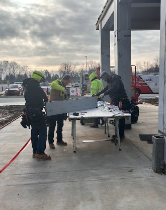 The CHHS Construction Crew works on the finishing touches of the new main entryway on Dec. 19. Students and teachers are not the only ones in the Christmas spirit. Their background music on this second-to-the-last school day of 2024 spread the message, "We wish you the merriest, the merriest/the merriest, yes the merriest. . . . " Happy Holidays to our hardworking construction crew!