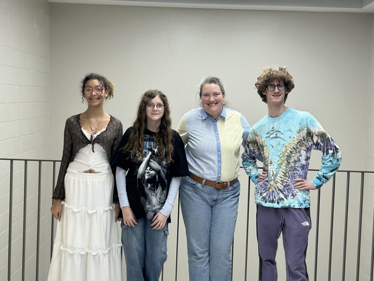 Freshmen Jaelynn Hughes and Tayla Jecker, math teacher April York, and senior Preston Meredith dress in their favorite decades for spirit week. They are all a part of the Academic Team. Feb. 5.