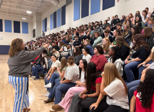 Juniors answer questions for candy as principal Kim Case reviews the points from her presentation to the class on Aug. 15. Case conducted meetings with all grade levels throughout the day.