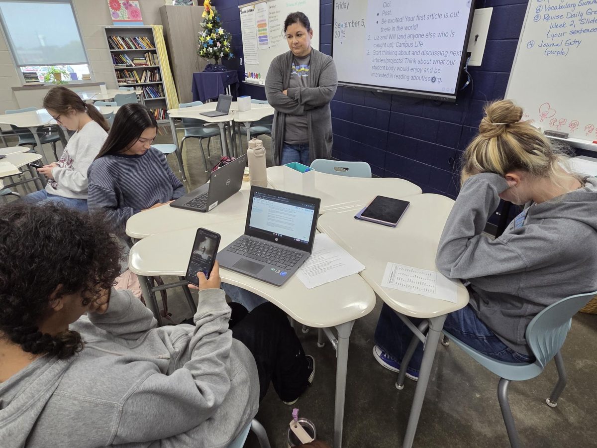 Various students on their phone during class. Likely to become a much more rare event.