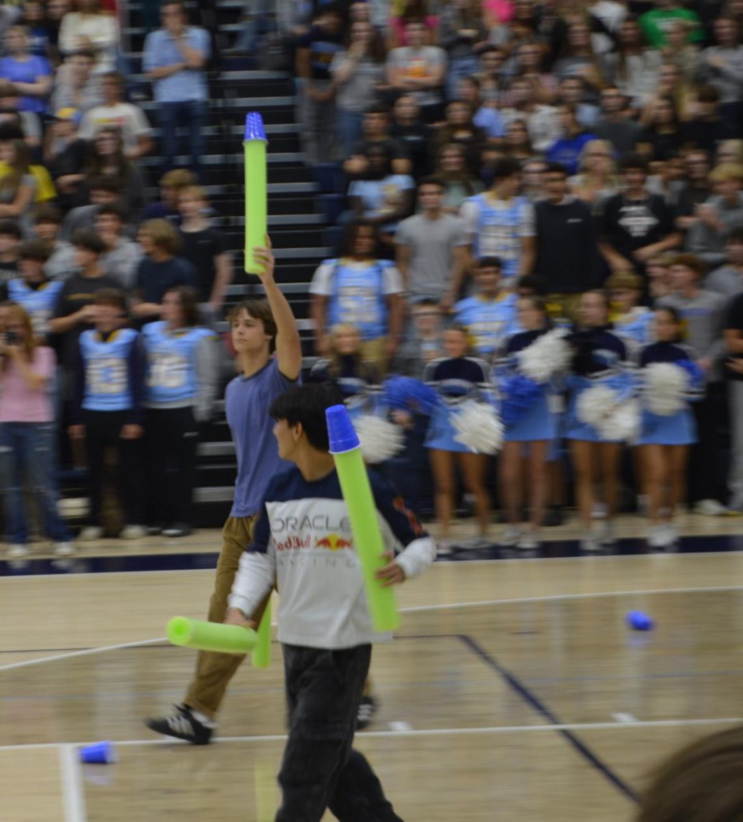 Junior Alex Cabral and senior Reed Mouser face off in the Cup Of Noodles game during the pep rally on Sept. 26.