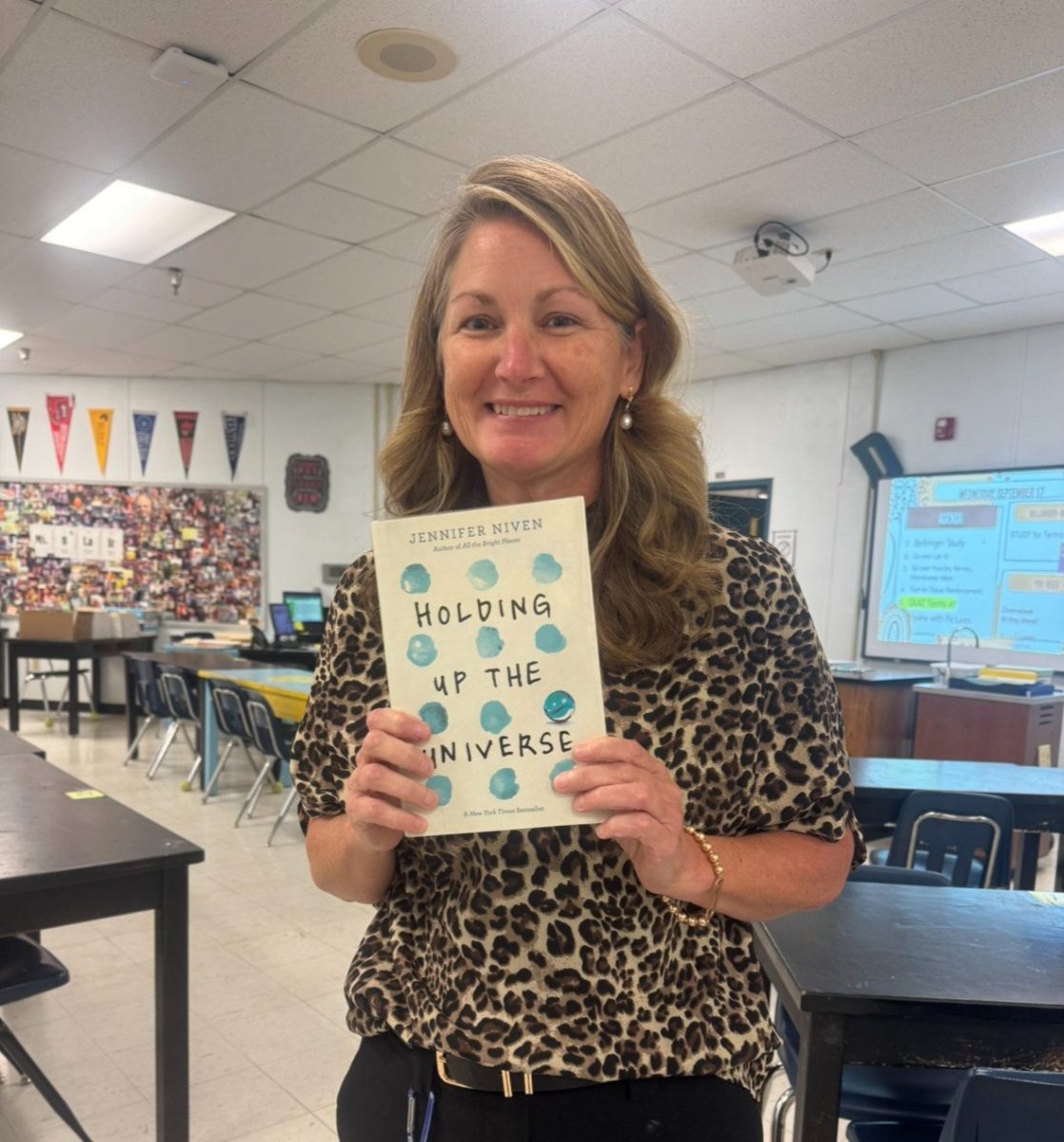 Science teacher  Leann Blair smiles with  her honor book donated by Emily Crewz, Class of 2011. (Sept. !7)