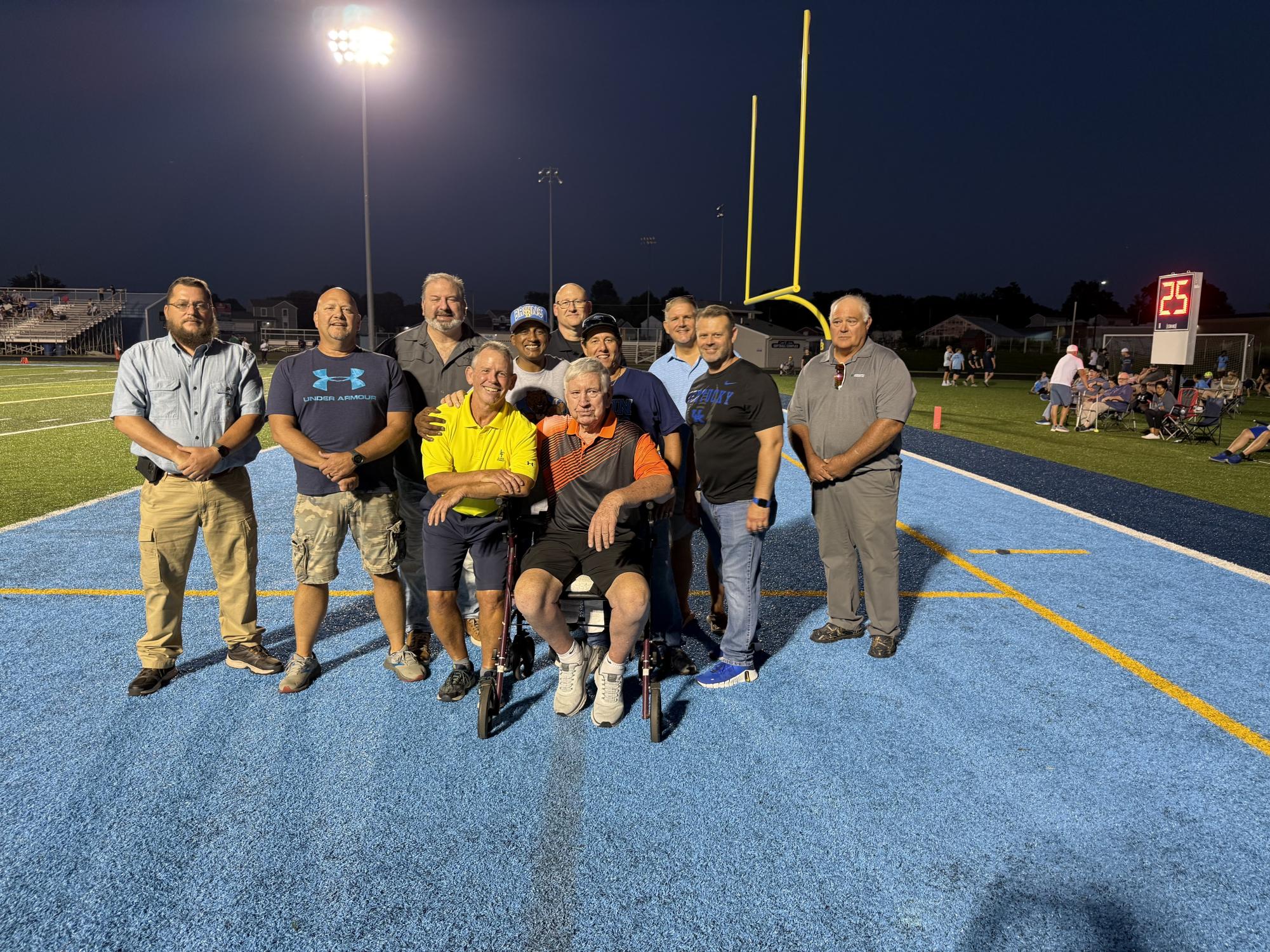 Football players and coaches from the original Bruin team gather on the Central Hardin Bruin field. (Aug. 22)