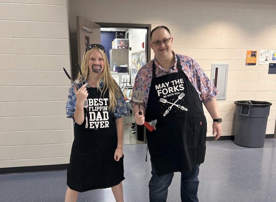 Junior Emma Browning and English teacher  Mr. Newsome pose with tongs and a spatula in their BBQ dad outfits for homecoming spirit week on Sep. 25. 