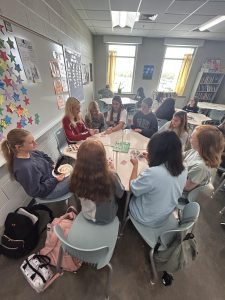 A group of students play a game of cards in Ms. Sherrard’s room during PowerHour, September of 2024. Students use PowerHour as a break from their stressful day as they have fun and socialize with one another.