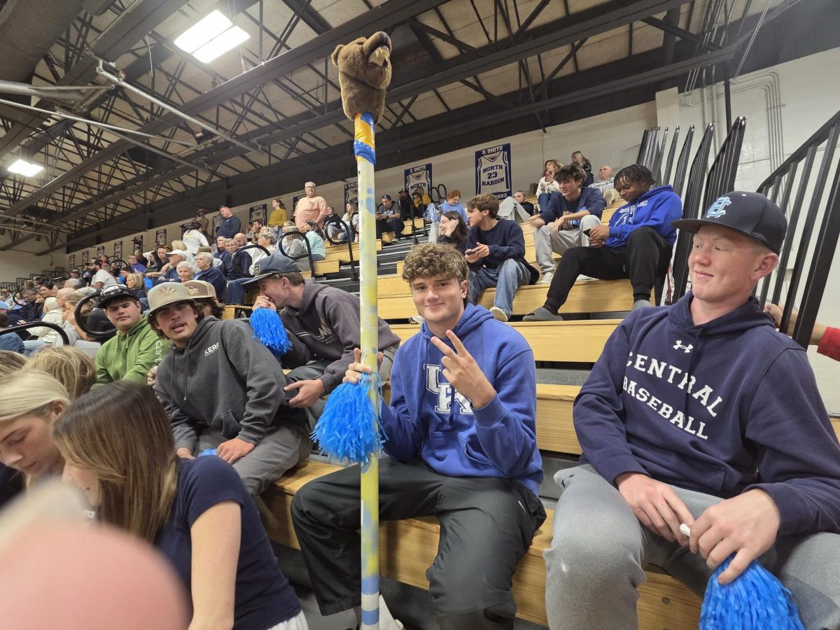 Senior Caleb Irwin proudly wields the Bruin spirit stick at 17th district volleyball tournament championship on Oct 23.