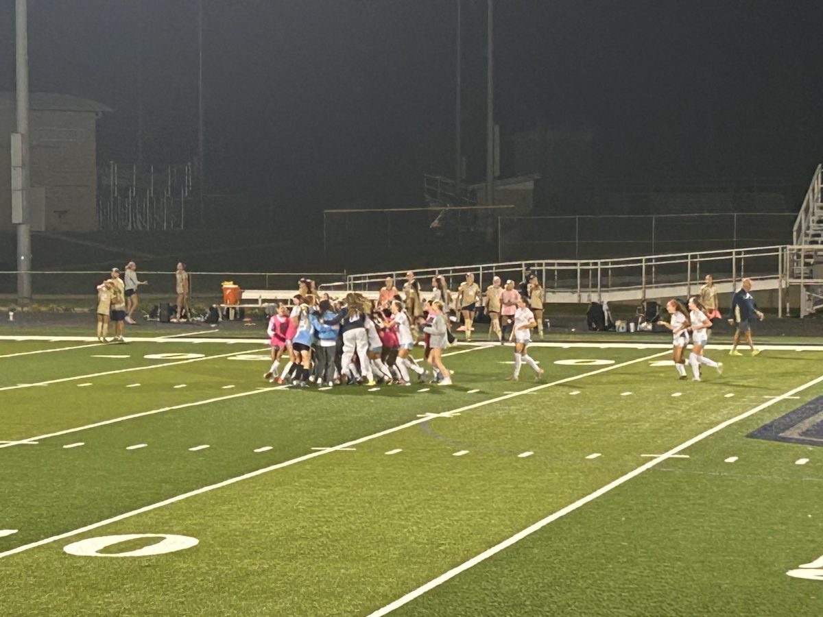REGION CHAMPS! Girls' soccer team rallies on the field in celebration after beating the ranked Elizabethtown team 1-0 on Oct. 15. This is the sixth contest win in a row for the girls soccer team. 